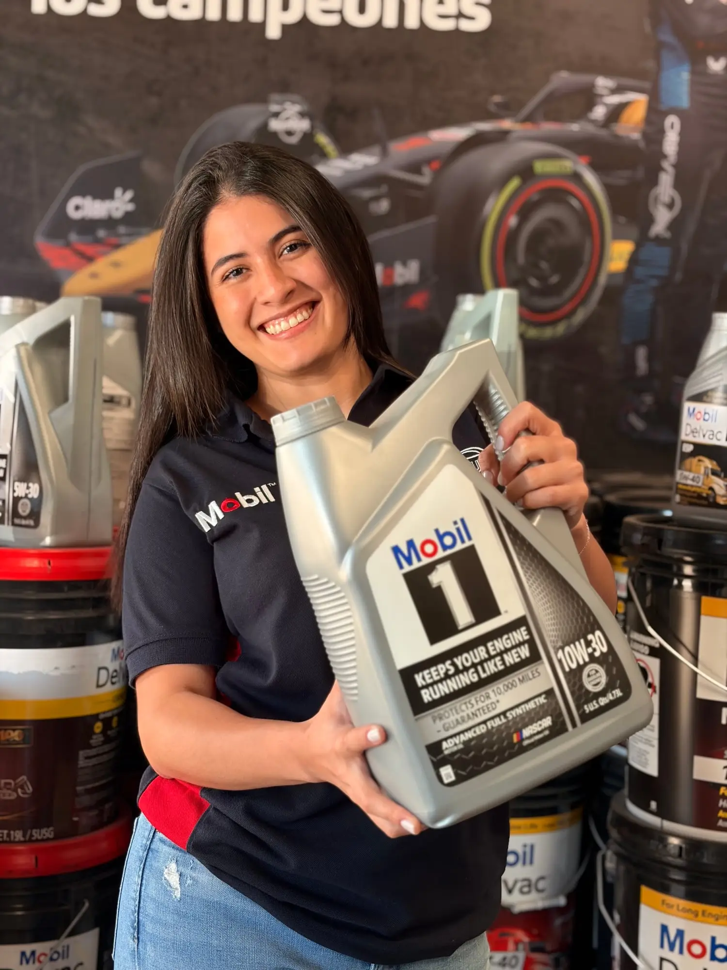 Asesora de CR Autos sosteniendo un galón de aceite de motor Mobil 1